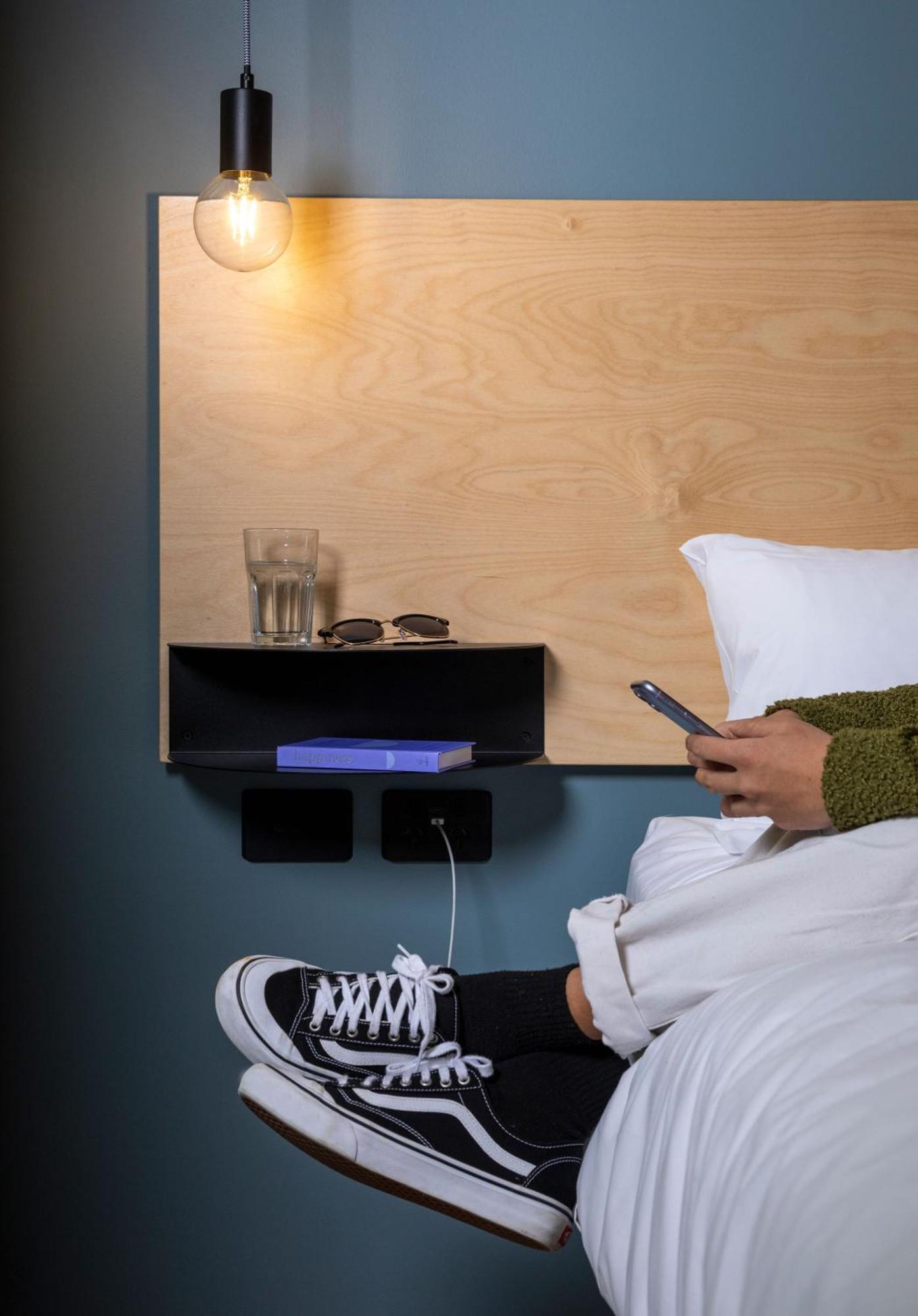 Lylo Auckland Hotel Δωμάτιο φωτογραφία A phone being used in bed